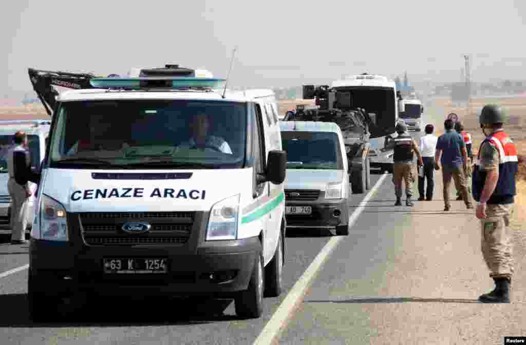 A funeral transport vehicle (front) carrying the bodies of drowned Syrian migrants, including three-year old boy Aylan Kurdi, drives to the Turkish-Syrian border in Suruc, bordering with the northern Syrian town of Kobani, Turkey, Sept. 4, 2015.