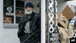 Charles O'Bryan, on probation for hoarding-related health code violations, stands outside his Cincinnati home in 2008.