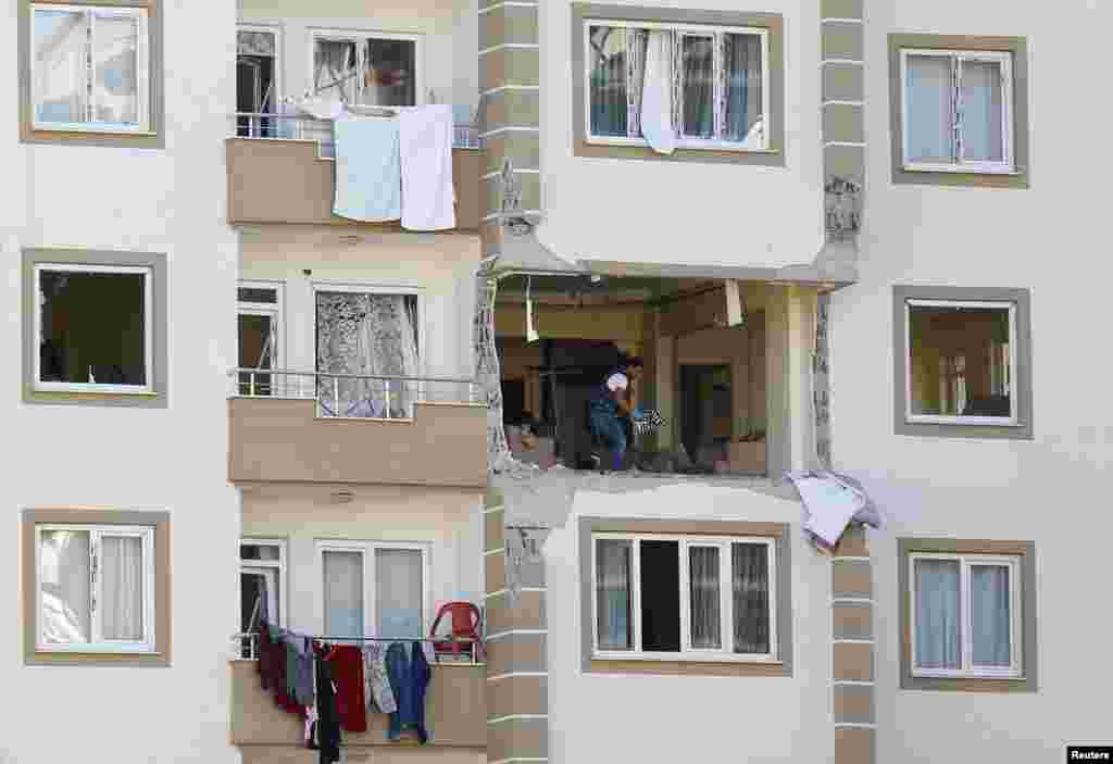 A police forensic expert examines an apartment after a blast in the southeastern city of Gaziantep, Turkey.