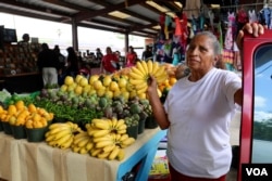 Maria Trinidad, from Guerrero, Mexico, runs a fruit and vegetable stand at Sunny Flea Market in Houston. (R. Taylor/VOA News)