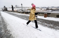 FILE - A woman cross-country skis across the medieval Charles Bridge in Prague, Czech Republic, February 9, 2021. (REUTERS/David W Cerny)