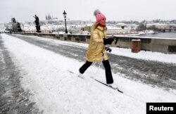 FILE - A woman cross-country skis across the medieval Charles Bridge in Prague, Czech Republic, February 9, 2021. (REUTERS/David W Cerny)