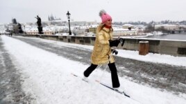 FILE - A woman cross-country skis across the medieval Charles Bridge in Prague, Czech Republic, February 9, 2021. (REUTERS/David W Cerny)