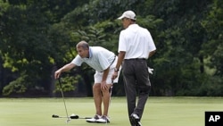 President Barack Obama and House Speaker John Boehner, left, are on the first hole of their game of golf at Andrews Air Force Base, Maryland, June 18, 2011