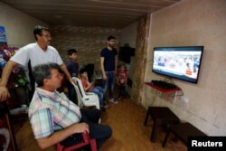 Palestinian refugee Khaled Ali Hassan, 53, watches the Nakba rally on television in Shatila refugee camp, in Beirut, Lebanon, April 19, 2018.