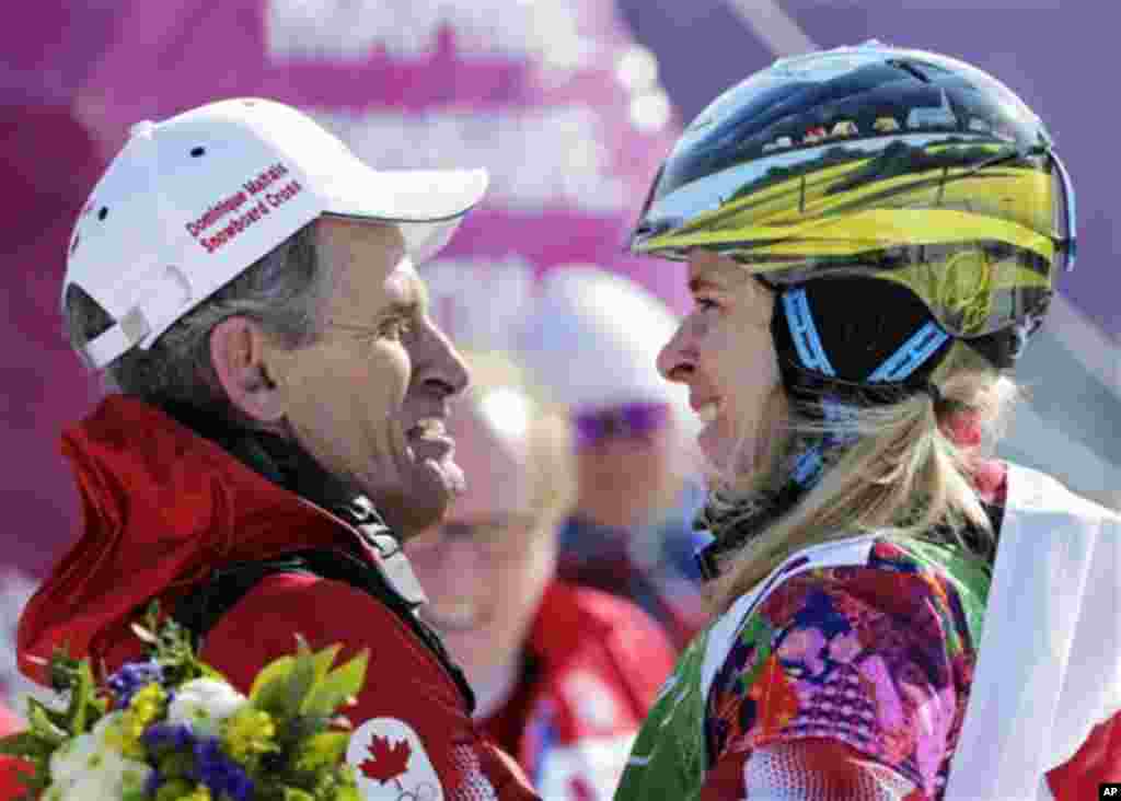 Dominique Maltais of Canada, right, celebrates with her father Gerald Maltais after taking the silver medal in the women's snowboard cross final at the Rosa Khutor Extreme Park, at the 2014 Winter Olympics, Sunday, Feb. 16, 2014, in Krasnaya Polyana, Russ