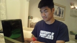 Engineering major Khang Nguyen, 22, checks his SmartyPig savings account