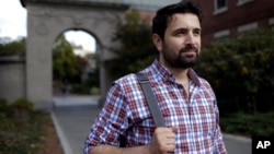 FILE - Khaled Almilaji is studying for a master's degree in public health at Brown University in Providence, R.I., Oct. 13, 2016. Almilaji is stuck in Turkey because President Donald Trump's executive order does not permit him to return to Providence where he lives with his pregnant wife.