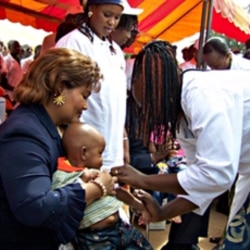 Chantal Compaore, the wife of Burkina Faso's president, holds a young boy during the launch of a new vaccination campaign against meningitis December 6