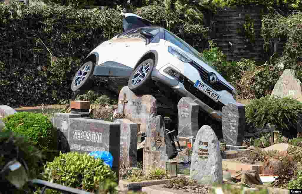 A car is pictured at a cemetary following heavy rainfalls in Dernau, Germany.