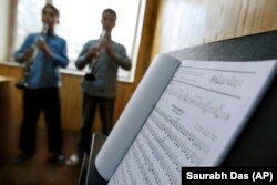 FILE - In this May 11, 2010 file photo, students learn to play music at the Afgan National Institute of Music, ANIM, in Kabul, Afghanistan.