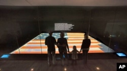 Visitors view the Star-Spangled Banner at the National Museum of American History.