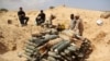 FILE - Libyan forces prepare to detonate and dispose of explosives and shells left behind by Islamic State militants in Sirte following a battle, in Misrata, Sept. 9, 2016.