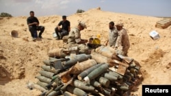 FILE - Libyan forces prepare to detonate and dispose of explosives and shells left behind by Islamic State militants in Sirte following a battle, in Misrata, Sept. 9, 2016.