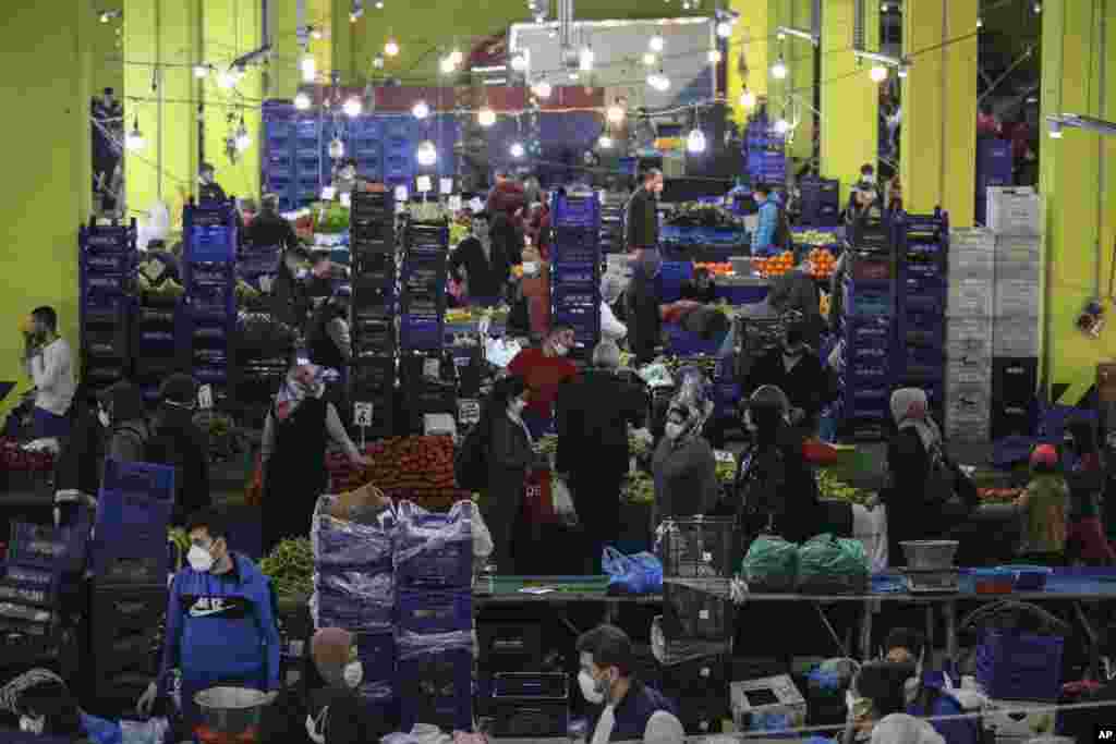 People shop at the local market in Istanbul, Turkey, a few hours before the start of the latest lockdown to help protect from the spread of the coronavirus.