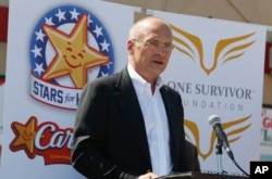 FILE - CKE Restaurants CEO Andy Puzder speaks at a news conference in Austin, Texas, Aug. 6, 2014.