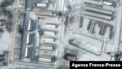 This handout satellite image released by Maxar Technologies shows armored personnel carriers and trucks at Klimovo storage facility, in Russia's Bryansk region, some 13 kilometers north of its border with Ukraine, Jan. 19, 2022.