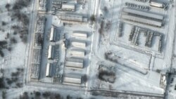 FILE - This handout satellite image released by Maxar Technologies shows armored personnel carriers and trucks at Klimovo storage facility, in Russia's Bryansk region, some 13 kilometers north of its border with Ukraine, Jan. 19, 2022.
