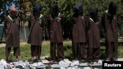 FILE - Insurgents suspected of belonging to the Haqqani network are presented to the media at the National Directorate of Security (NDS) headquarters in Kabul, Afghanistan, May 30, 2013.