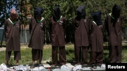 FILE - Insurgents suspected of being from the Haqqani network are presented to the media at the National Directorate of Security (NDS) headquarters in Kabul, Afghanistan, May 30, 2013.