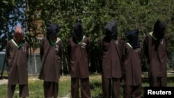 FILE - Insurgents suspected of being from the Haqqani network are presented to the media at the National Directorate of Security (NDS) headquarters in Kabul, May 30, 2013.