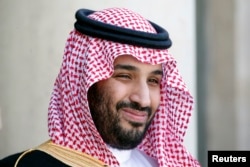 Saudi Arabia's Deputy Crown Prince Mohammed bin Salman reacts upon his arrival at the Elysee Palace in Paris, June 24, 2015.