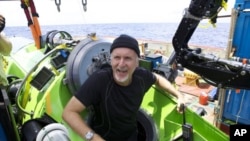 Filmmaker James Cameron emerges from the Deepsea Challenger after his successful solo dive to the Mariana Trench, the deepest part of the ocean. The director has donated the vessel to the Woods Hole Oceanographic Institution.