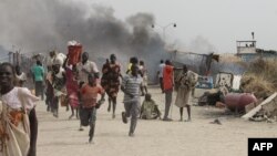 FILE - South Sudanese civilians flee fighting in an United Nations base in the northeastern town of Malakal on February 18, 2016, where gunmen opened fire on civilians sheltering inside killing 30 people and injuring 123 others.