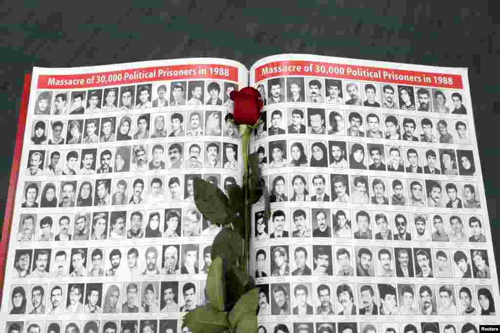 A rose rests on a page featuring photographs of people who have died in Iran as Iranian Americans from across California converge in Los Angeles, Jan. 11, 2020. to participate in the California Convention for a Free Iran and to express support for nationwide protests in Iran.