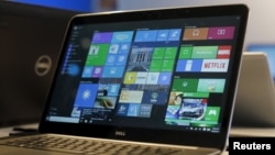FILE - A laptop computer featuring Windows 10 is seen on display at Microsoft Build in San Francisco, April 29, 2015. 