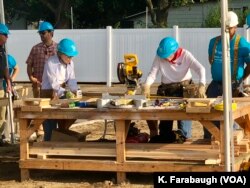 Former President Jimmy Carter and first lady Rosalynn Carter work on a Habitat for Humanity home for Ericka Santiestepan and her two young children in Mishawaka, Ind.