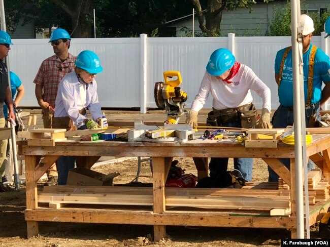 Former President Jimmy Carter and first lady Rosalyn Carter work on a Habitat for Humanity home for Ericka Santiestepan and her two young children in Mishawaka, Ind.