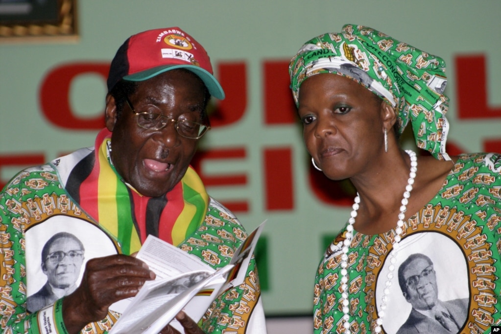 President Robert Mugabe talks to his wife Grace, at the launch of his party&#39;s manifesto and campaign in Harare, Feb. 29, 2008. (AP Photo)