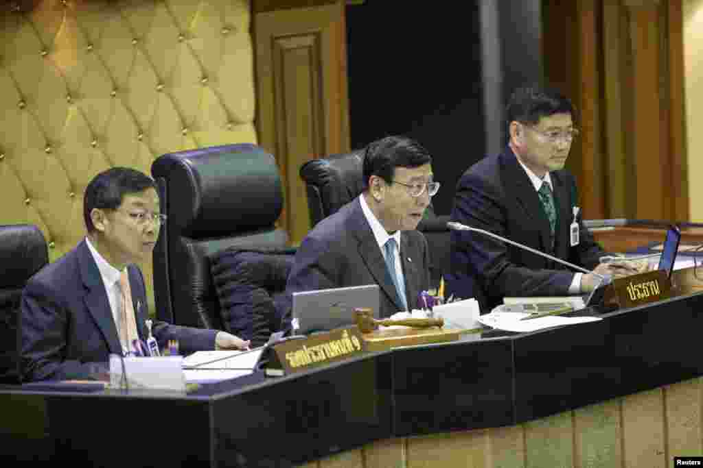 President of Thailand's National Legislative Assembly Pornphet Vichitcholchai, center, First Vice President Surachai Liengboonlertchai, left, and Second Vice President Peerasak Phortjit speak during a parliamentary session at parliament house in Bangkok A