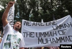 FILE - A supporter of the Islamist Hizb ut-Tahrir movement attends a rally in Simferopol, the administrative center of Crimea in southern Ukraine, June 6, 2013.