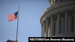 USA, Washington, The American Flag flies at the U.S. Capitol
