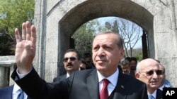 Turkey's President Recep Tayyip Erdogan waves after he visited the graves of three conservative late Turkish prime ministers, in Istanbul, April 17, 2017.