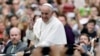 Pope Francis acknowledges faithful as he parades on his way to celebrate Mass in Philadelphia, Sept. 27, 2015.