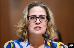 FILE - Sen. Kyrsten Sinema, D-Ariz., speaks during a committee hearing on Capitol Hill in Washington, Oct. 19, 2021.