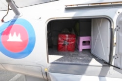 A box containing swab samples from cruise ship passengers sits in a helicopter before being transported to phnom Penh for testing in Sihanoukville, Cambodia, Thursday, Feb. 13, 2020.