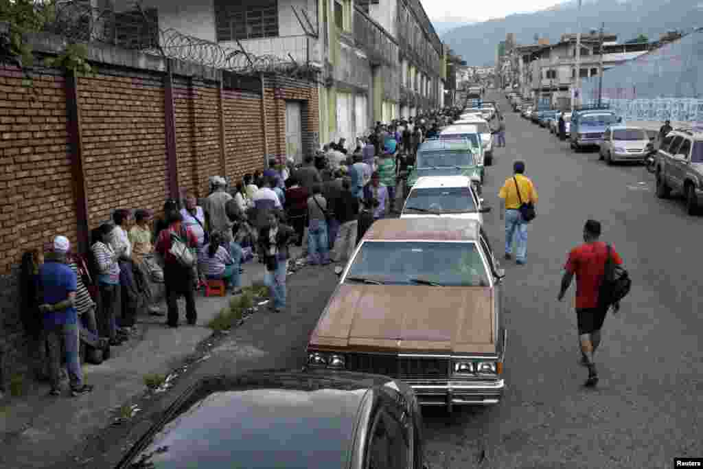 People line up for gas near a station of the Venezuelan state-owned oil company PDVSA in San Cristobal, Venezuela.