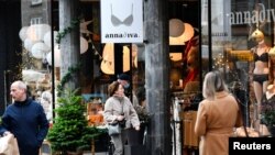 People do their Christmas shopping before the Dutch government's expected announcement of a 'strict' Christmas lockdown to curb the spread of the Omicron coronavirus variant, in Nijmegen, Netherlands, Dec. 18, 2021. 