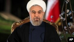 In this photo released by the official website of the Iranian Presidency office on Thursday, March 20, 2014, Iranian President Hassan Rouhani delivers a message for the Iranian New Year, or Nowruz, in Tehran, Iran