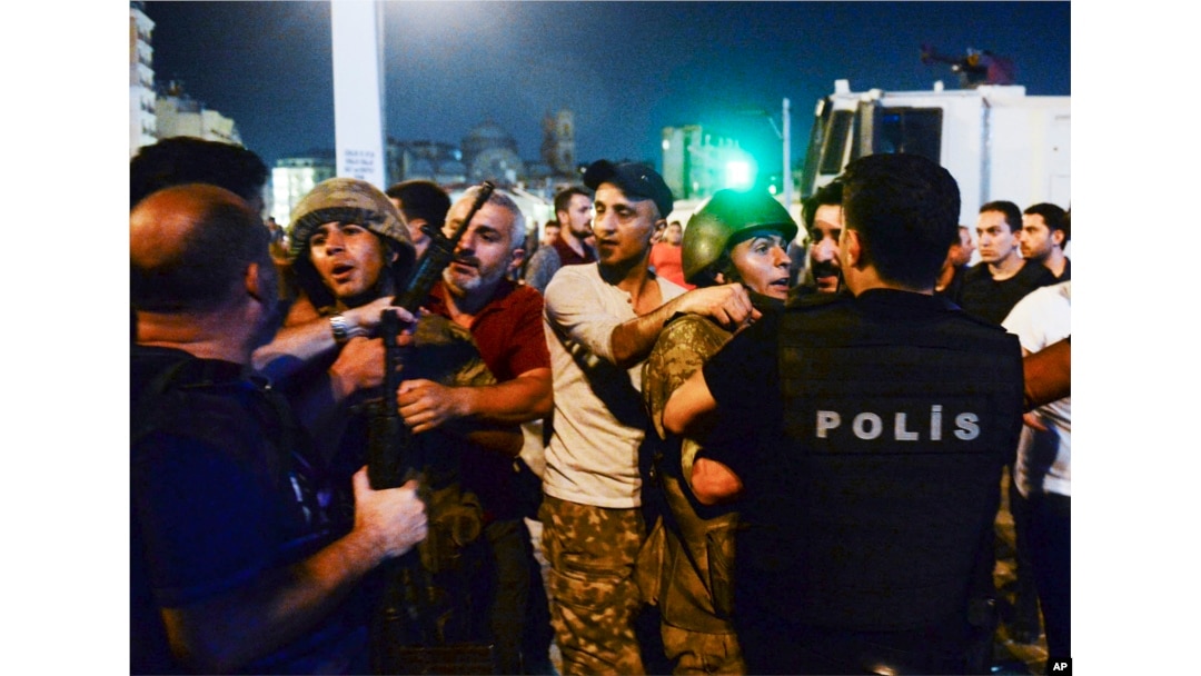 Turkish soldiers, arrested by civilians after an attempted coup, are handed to police officers in Istanbul on July 16, 2016.