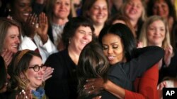 First lady Michelle Obama hugs 2017 School Counselor of the Year Terri Tchorzynski, after her final speech as First Lady at the 2017 School Counselor of the Year ceremony in the East Room of the White House in Washington, Jan. 6, 2017.