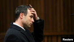 Olympic and Paralympic track star Oscar Pistorius gestures during his trial for the murder of his girlfriend Reeva Steenkamp, at the North Gauteng High Court in Pretoria, July 8, 2014. 