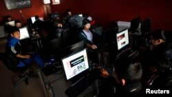 People use computers at an Internet cafe in Ankara, Feb. 6, 2014. 