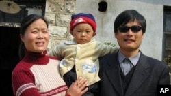 This undated photo provided by the China Aid Association shows blind Chinese legal activist Chen Guangcheng, right, with his son, Chen Kerui, with his wife Yuan Weijing, left, in Shandong province, China. 