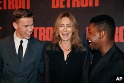 FILE - Actors John Boyega, right, and Will Poulter, left, and director Kathryn Bigelow pose for photographers during the photocall of the film 'Detroit', in Paris, Sept. 29, 2017.