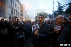 Demonstrators hold picture of Bar Association President Tahir Elci during a protest in Istanbul, Turkey, Nov. 28, 2015.